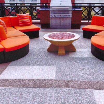 Outdoor seating area featuring stylish patio furniture on a modern surface, showcasing high-quality Decorative Concrete Services for durable and elegant outdoor living spaces.