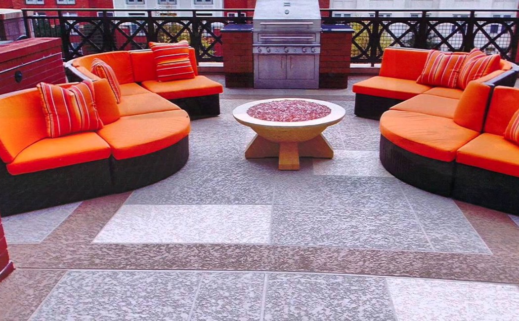 Outdoor seating area featuring stylish patio furniture on a modern surface, showcasing high-quality Decorative Concrete Services for durable and elegant outdoor living spaces.