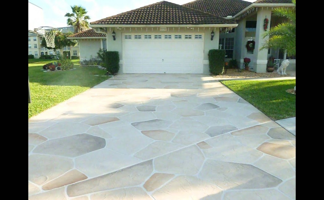Professional Decorative Concrete driveway featuring a clean stamped stone pattern that enhances the home’s curb appeal with a durable, elegant finish.